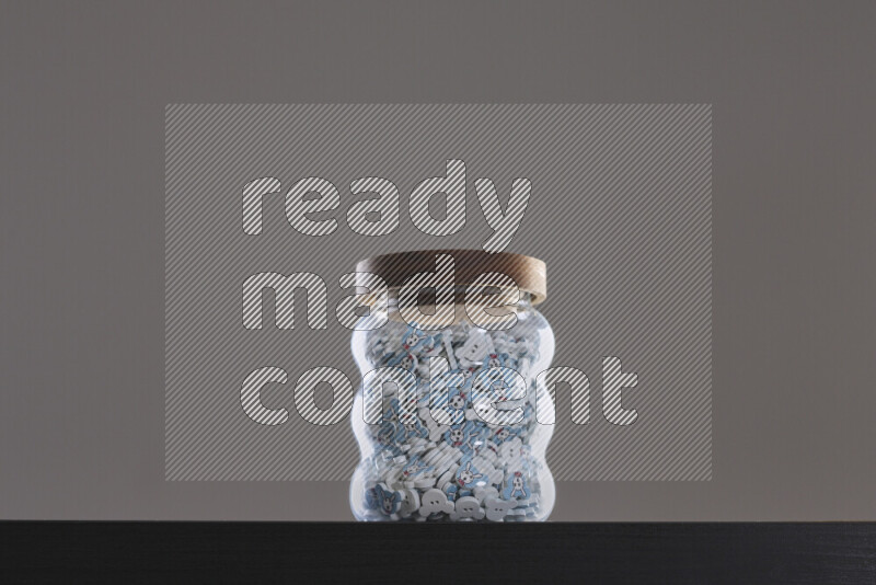 Buttons in a glass jar on black background
