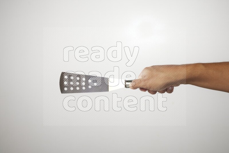 Male Hand Holding Burger Flipper on white background