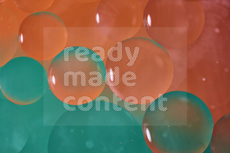 Close-ups of abstract oil bubbles on water surface in shades of green and orange