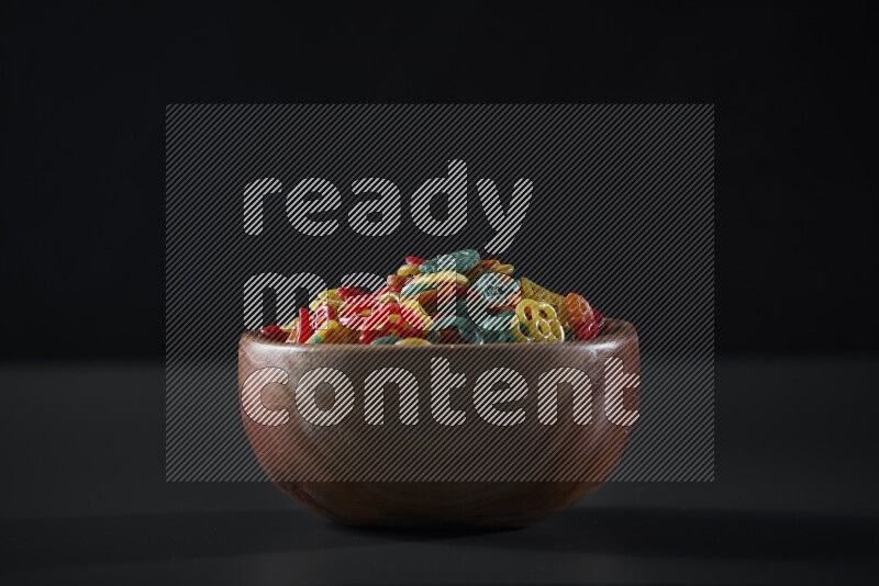 Snacks in a wooden bowl on grey background