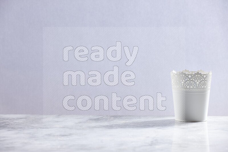An empty white plant pot on grey marble background