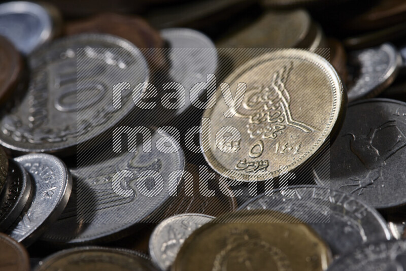 A close-ups of random old coins on black background