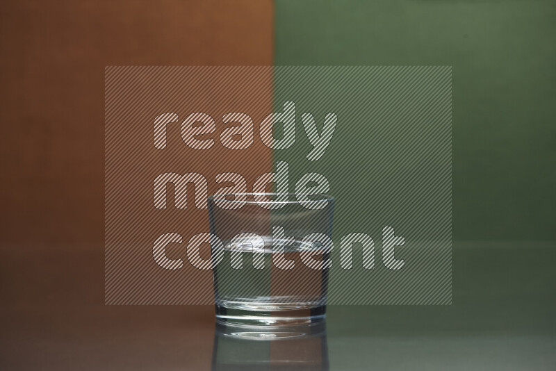 The image features a clear glassware filled with water, set against brown and dark green background