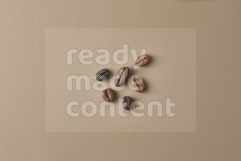 Roasted coffee beans on beige background