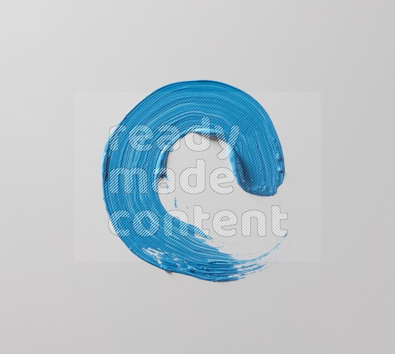 A single blue curved brush stroke on a white background