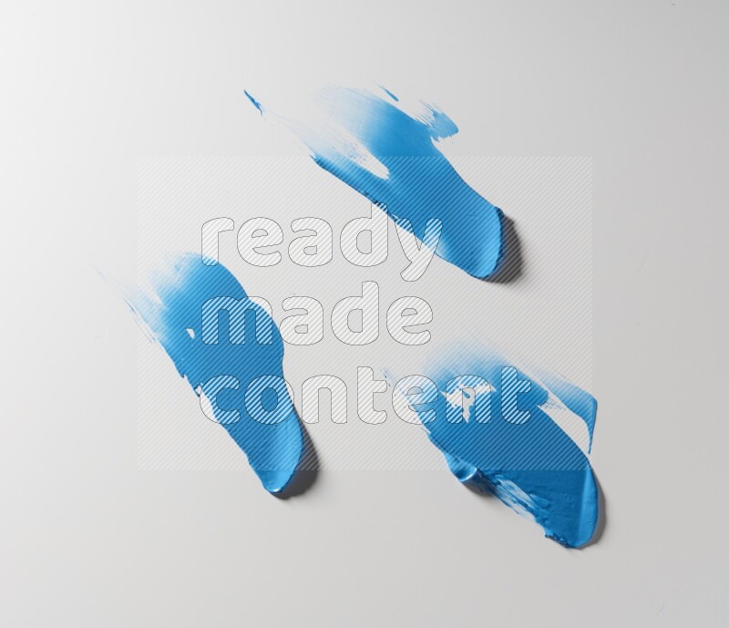 Blue painting knife strokes on white background