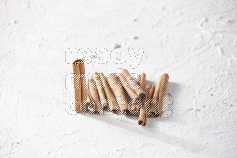 Cinnamon sticks on a textured white background
