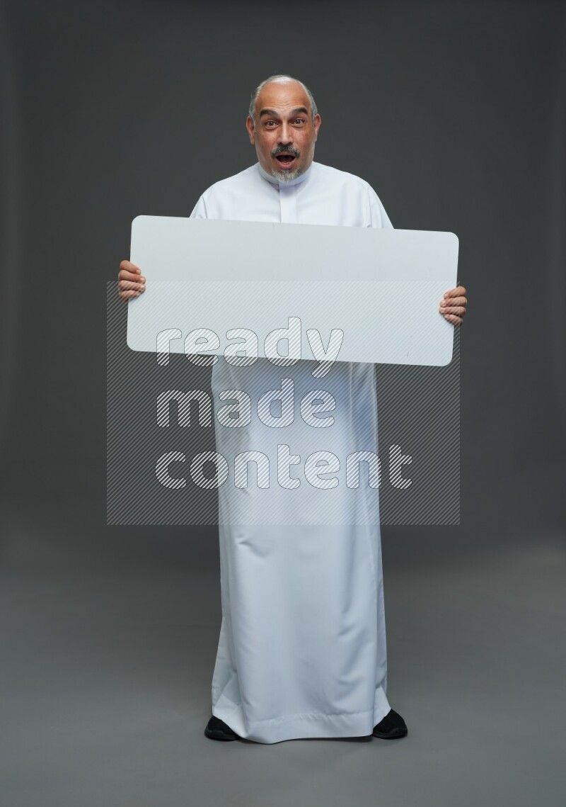 Saudi man without shomag Standing holding social media sing on gray background