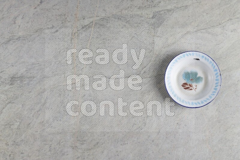 A vintage metal plate on grey marble background