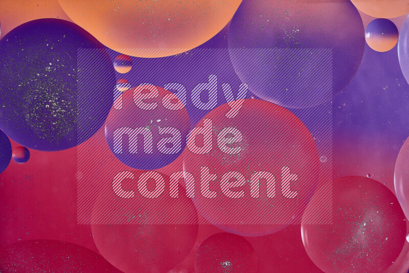 Close-ups of abstract oil bubbles on water surface in shades of red, orange and purple