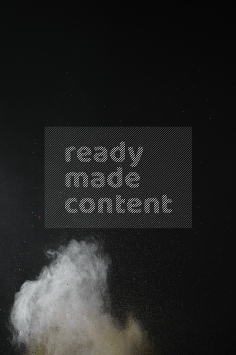 A side view of brown powder explosion on black background