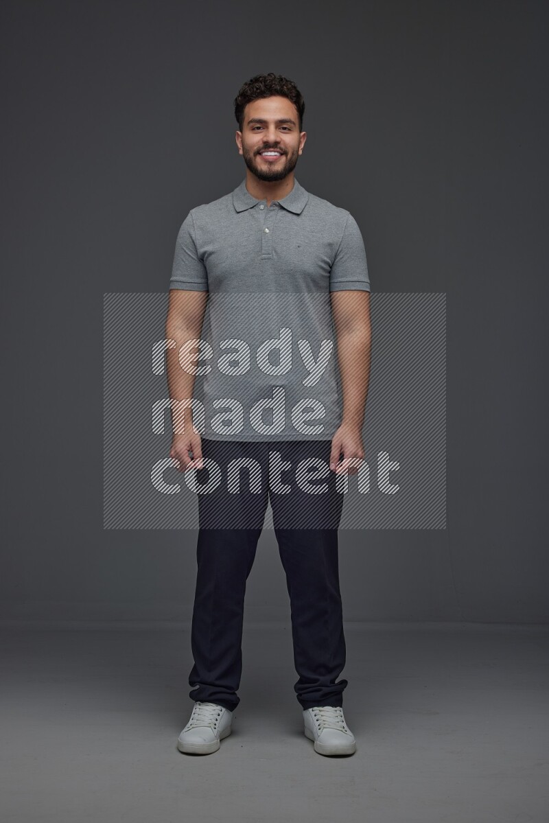 A man wearing casual making multi stand poses  eye level on a gray background