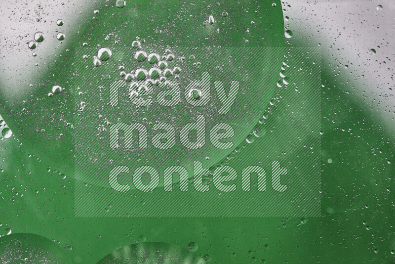 Close-ups of abstract oil bubbles on water surface in shades of white and green