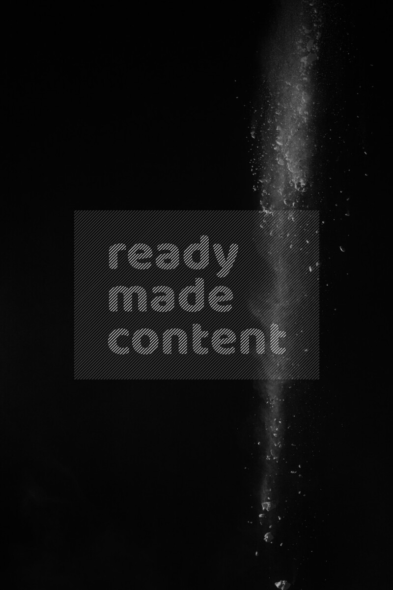 A side view of white powder explosion on black background