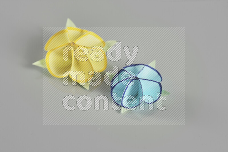 Origami flower on grey background