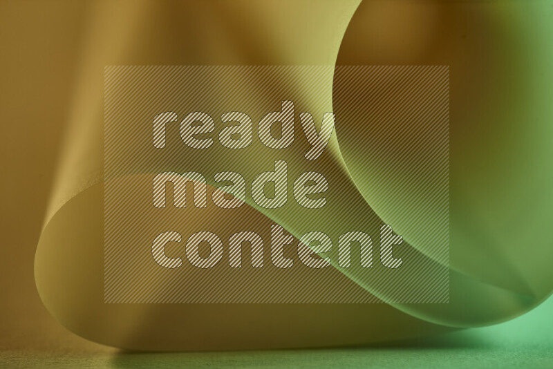 An abstract art piece displaying smooth curves in green and yellow gradients created by colored light