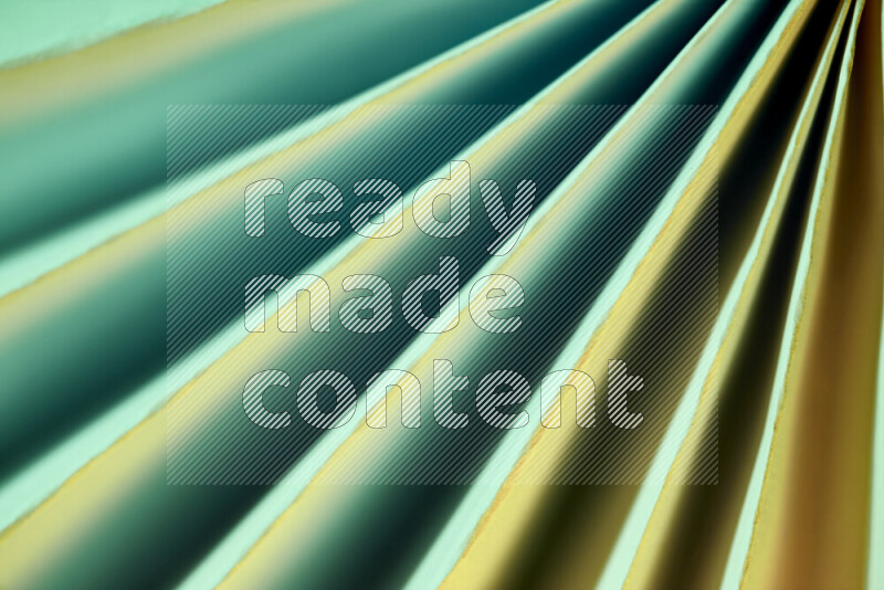 An image presenting an abstract paper pattern of lines in green and gold tones