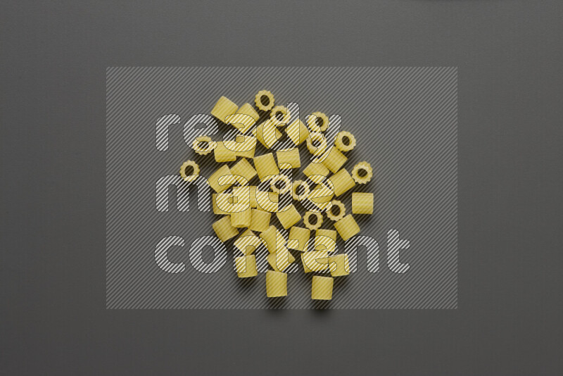 Small rings pasta on grey background