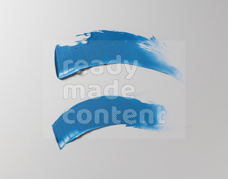 Blue curved painting knife strokes on white background